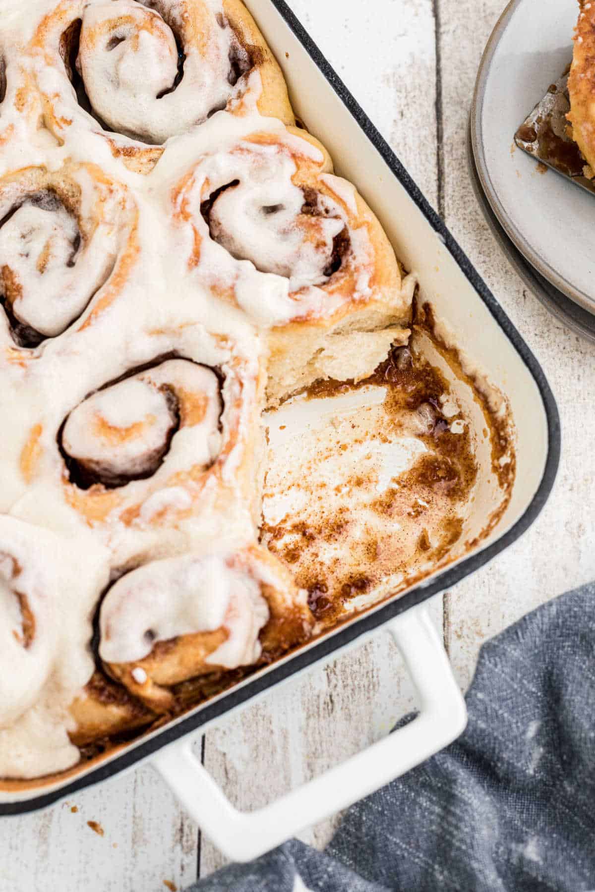 Overhead shot of a pan of Amish Cinnamon Rolls with one missing.