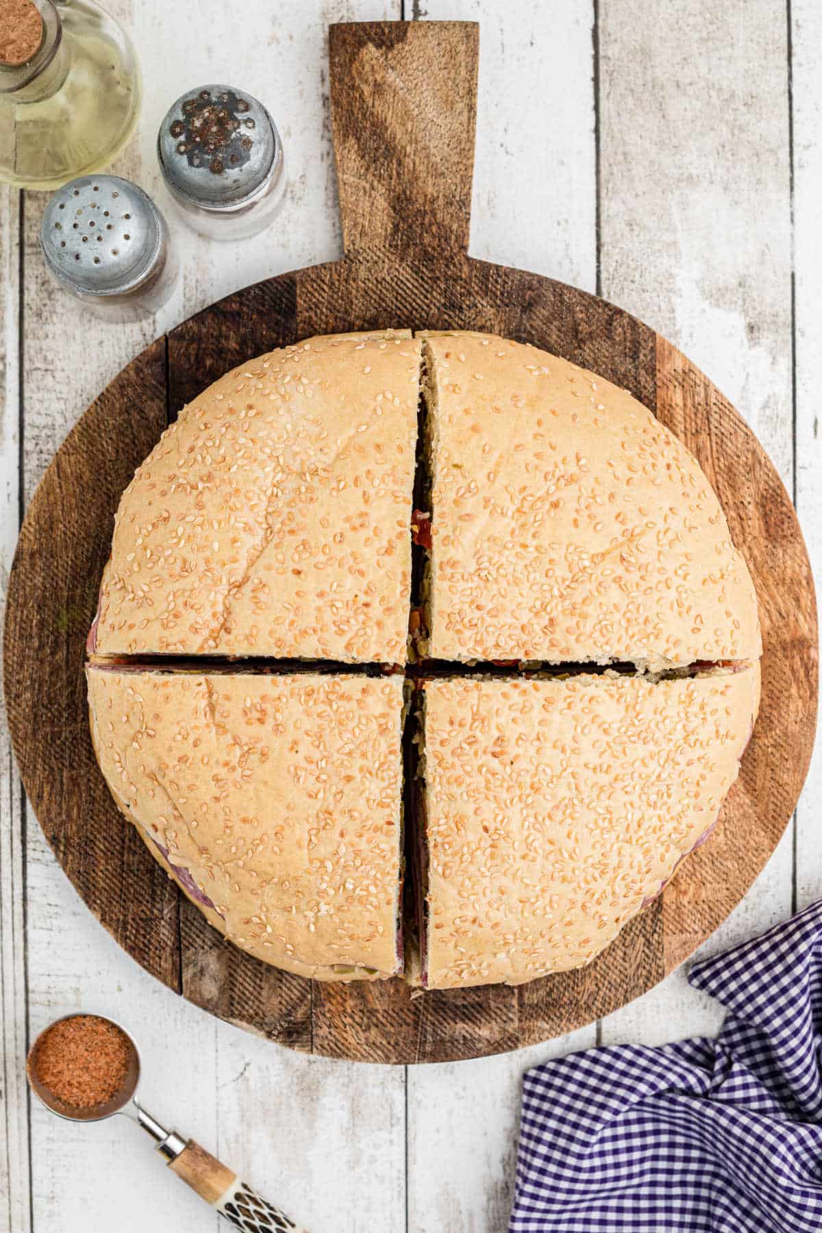 Overhead shot of a Cajun Muffuletta Sandwich cut into four.