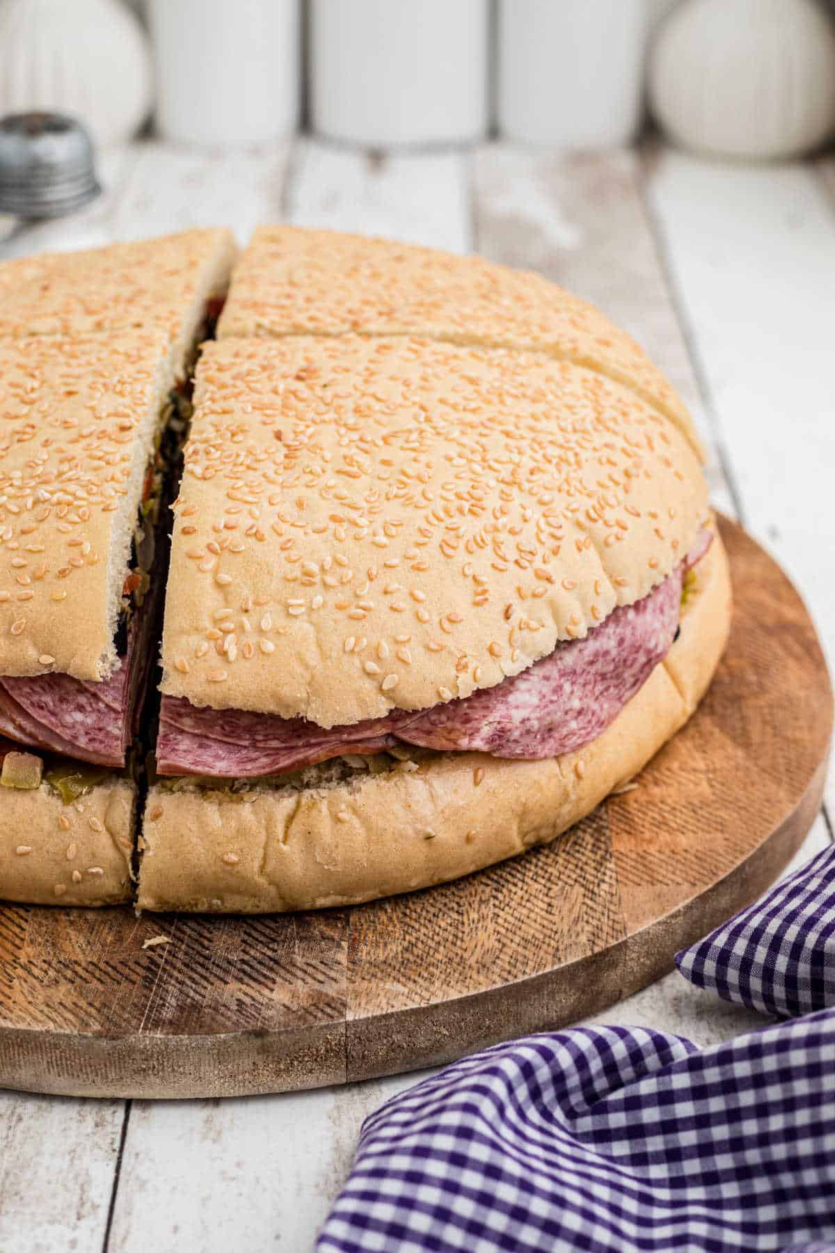 Side shot of a Cajun Muffuletta Sandwich.