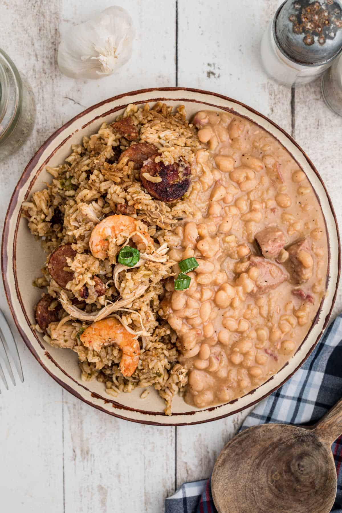 A dished out plate of Cajun Jambalaya with some white beans on the side.