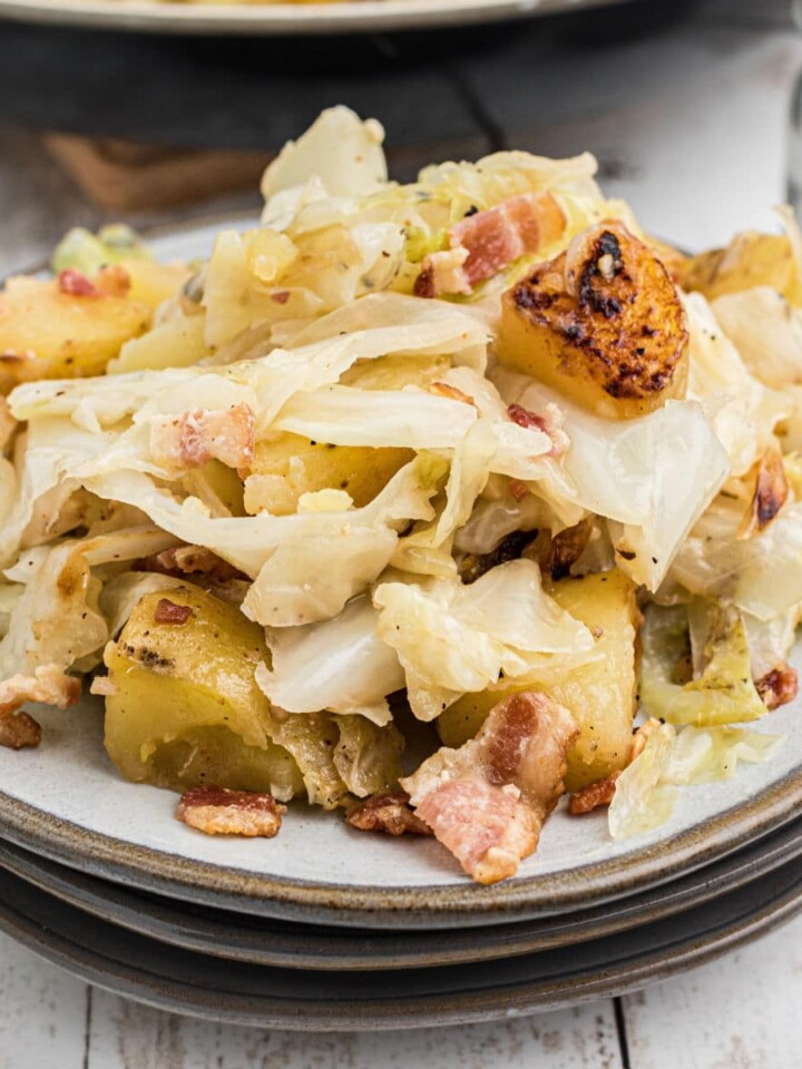 Plate full of fried cabbage and potatoes.