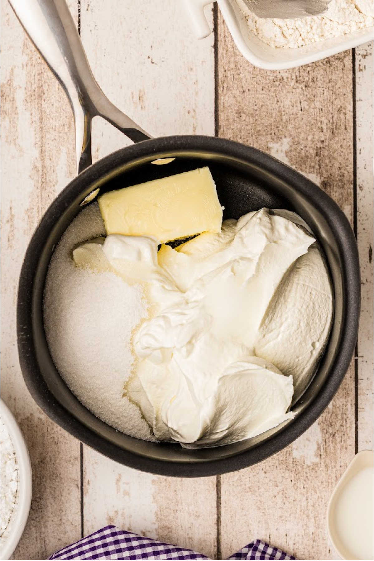 A pot with butter sugar etc ready to be melted.