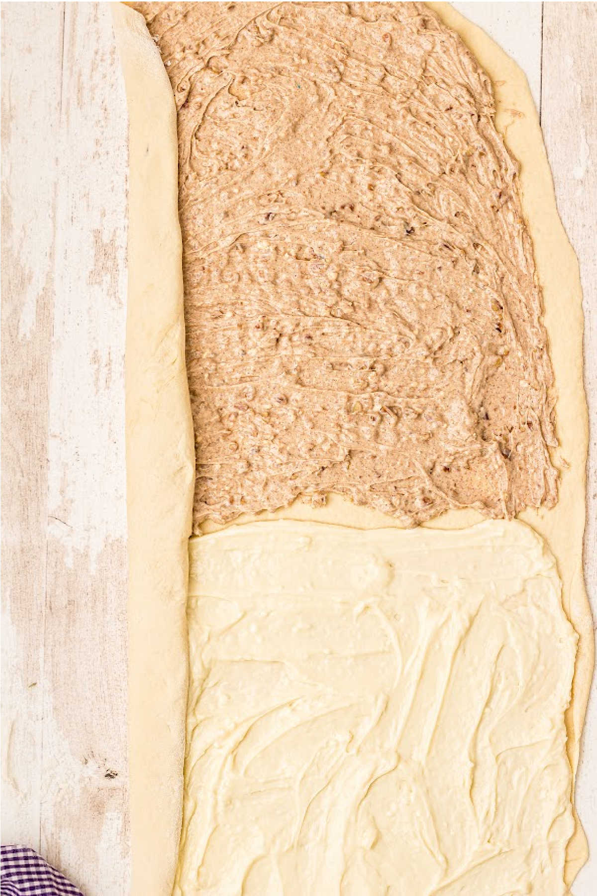 A dough with filling being rolled up.