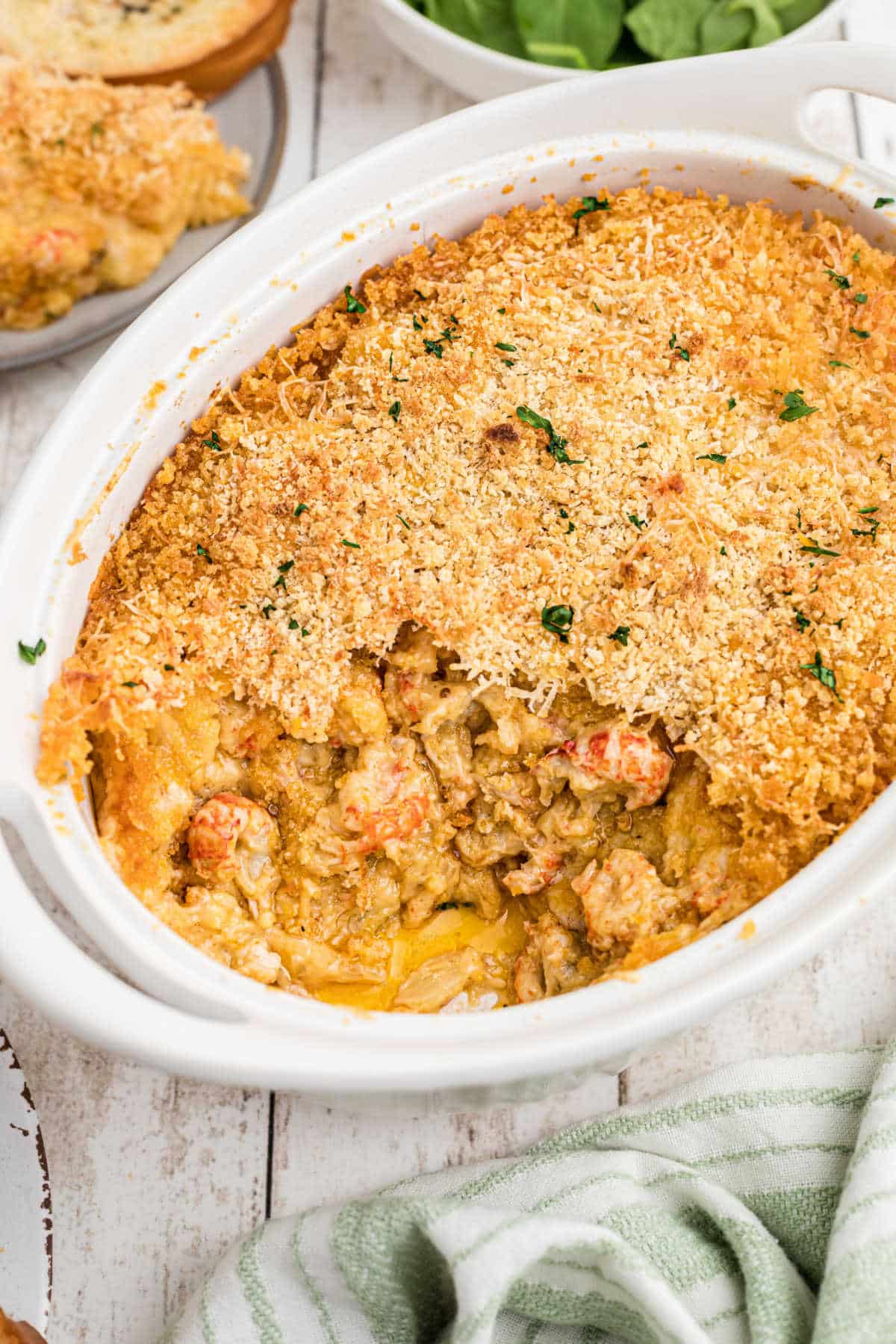 Portrait shot of a dish full of crawfish au gratin.