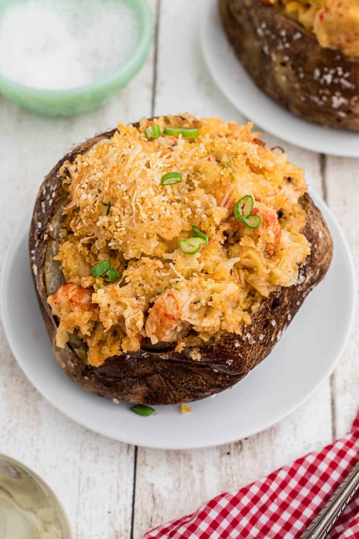 A baked potato stuffed with crawfish au gratin.