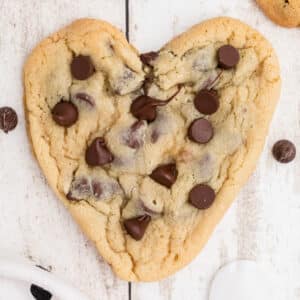 Overhead picture of heart shaped chocolate chip cookies, cropped square.