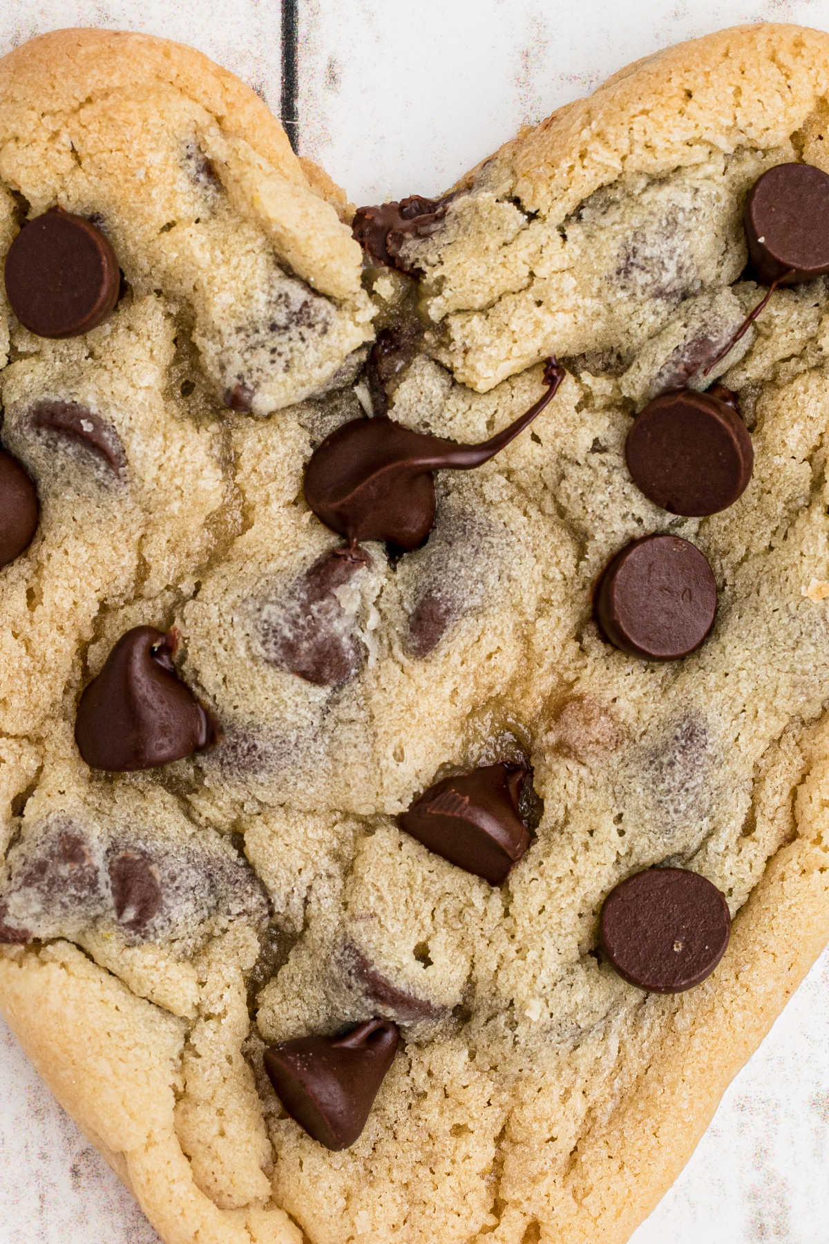 Very close up shot of a heart shaped chocolate chip cookie.
