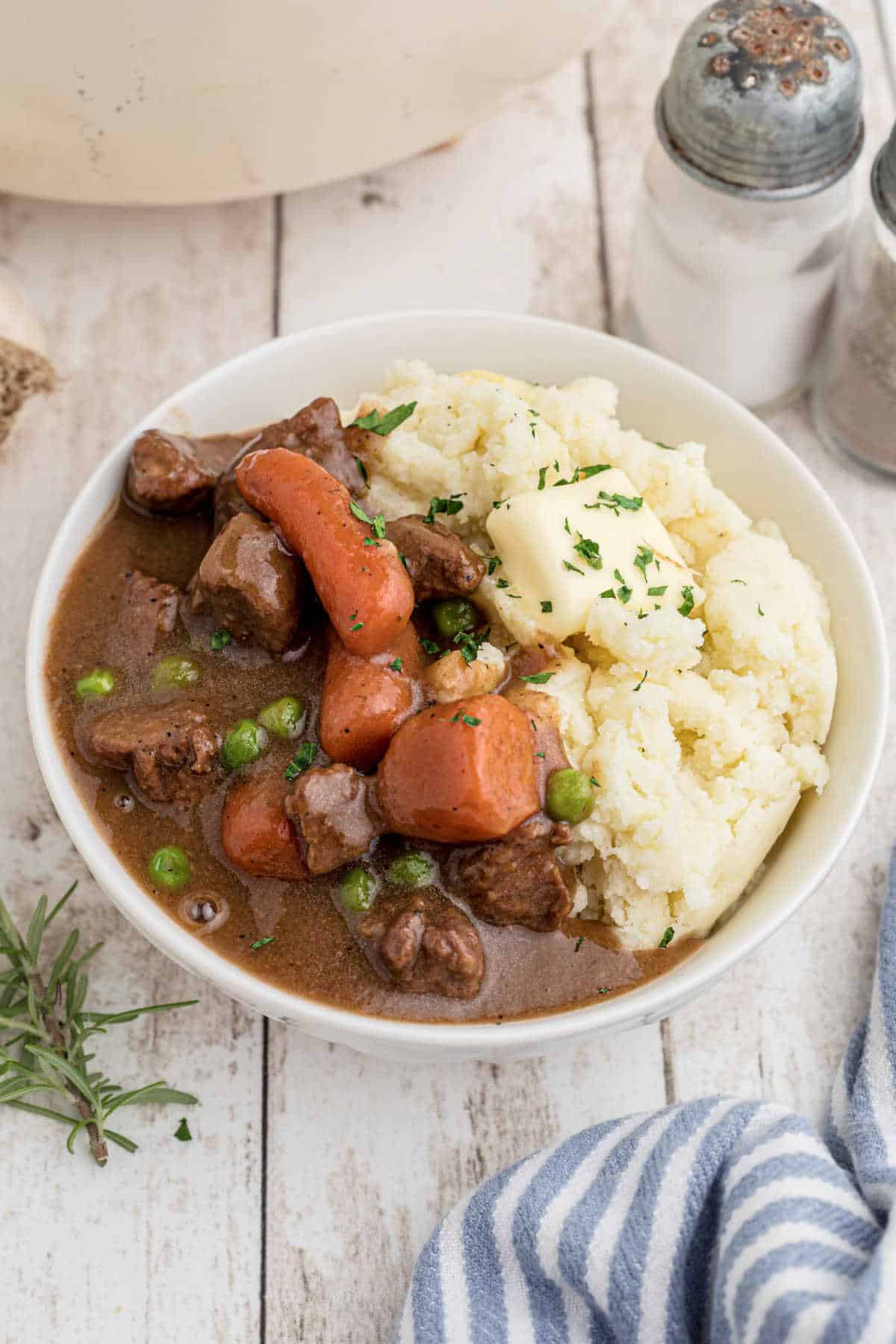 Side view of a bowl full of Irish Stew with Mashed Potatoes.