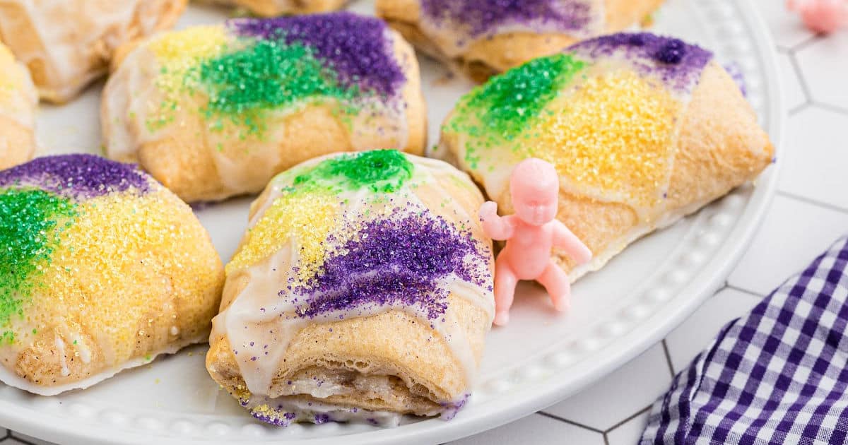 Close up of a King Cake Bite with a plastic baby resting next to it.