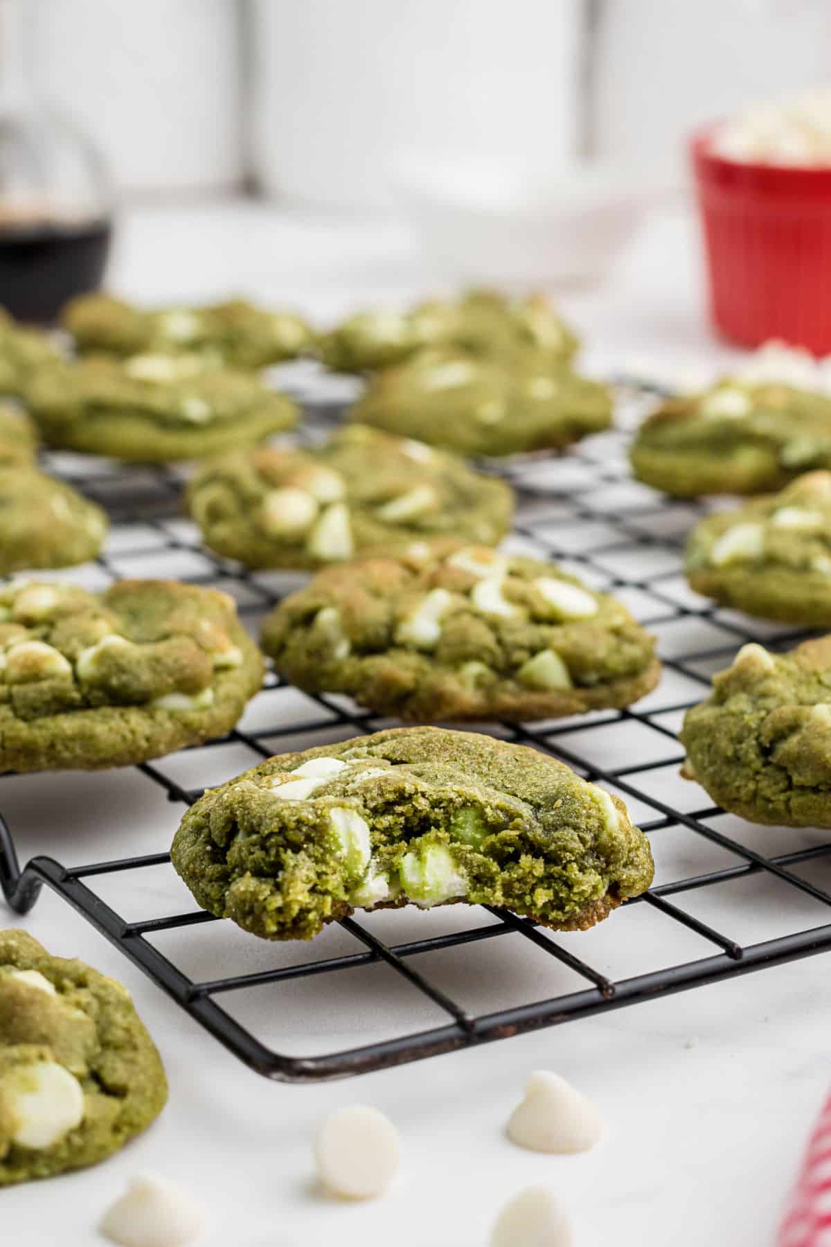 Close up shot of a matcha cookie with a bite taken out.