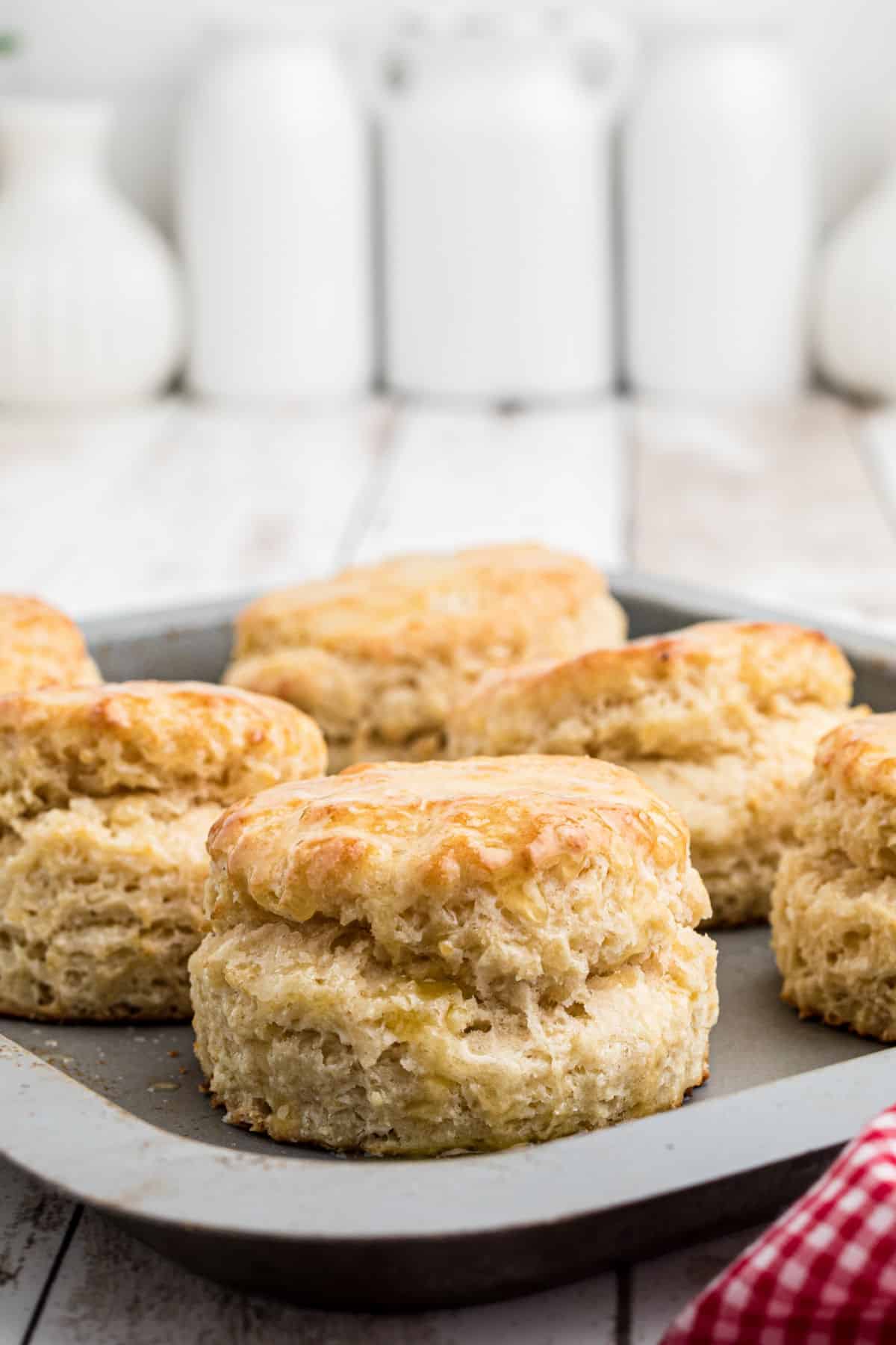 A baking tray filled with old fashioned southern biscuits.