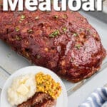 A smoked meatloaf on a pan with an inlay picture of a plated dish of smoked meatloaf and mashed potatoes, with text overlay for pinterest.