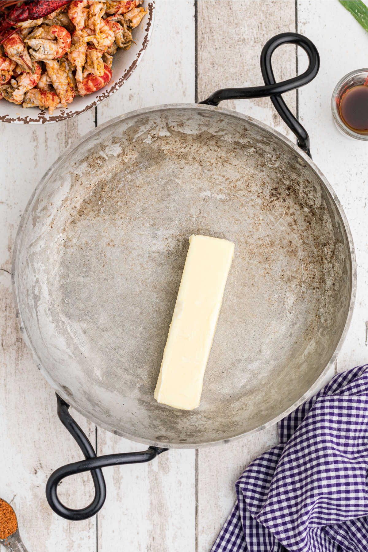 A skillet with a stick of butter.