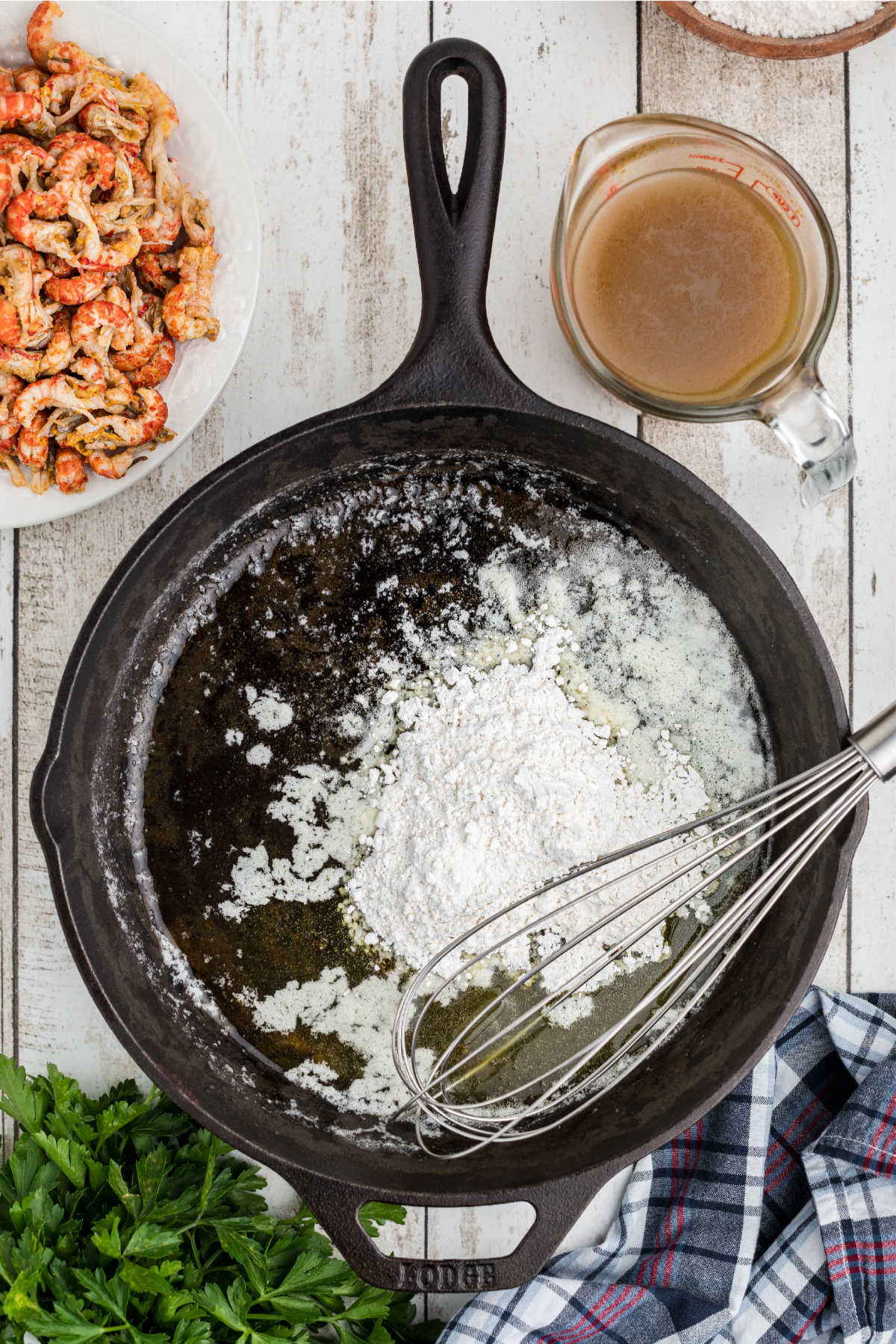 Flour added to a black skillet.