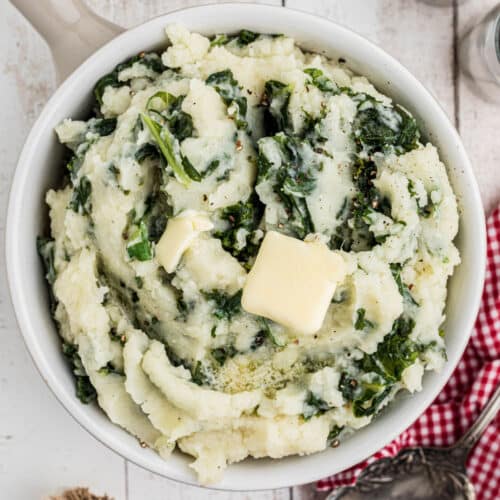 Overhead shot of a bowl of traditional colcannon with a butter slice melting on top.