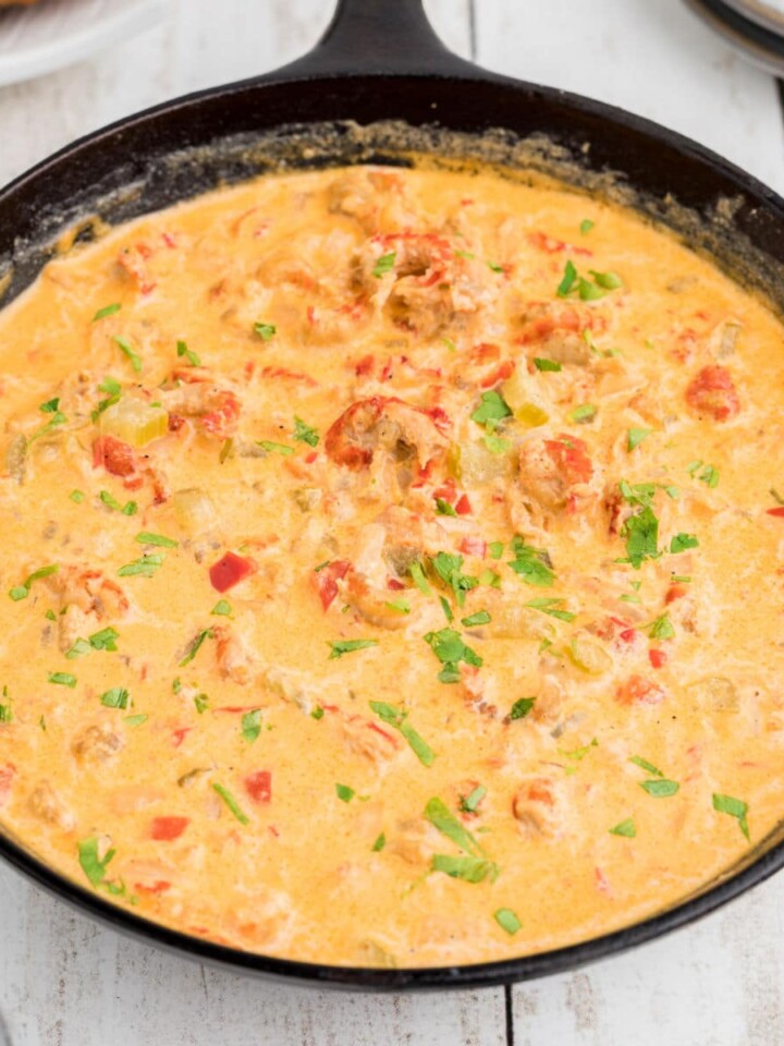 Side view of a skillet full of crawfish sauce.
