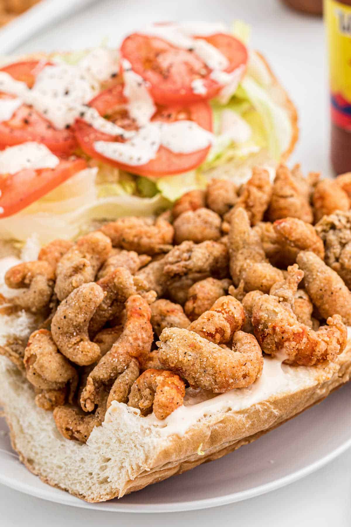Side view of a fried crawfish poboy.