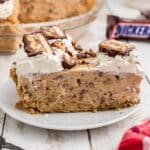 A close up of a slice of no bake snickers pie.