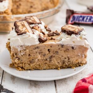A close up of a slice of no bake snickers pie.