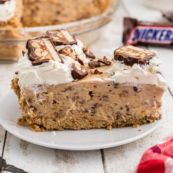 A close up of a slice of no bake snickers pie.