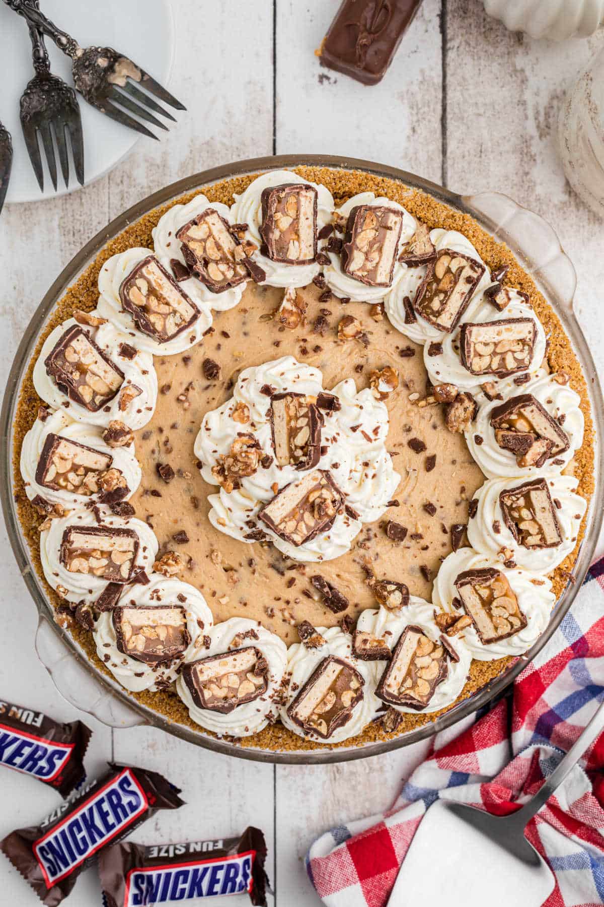Overhead shot of a no bake snickers pie, beautifully decorated.