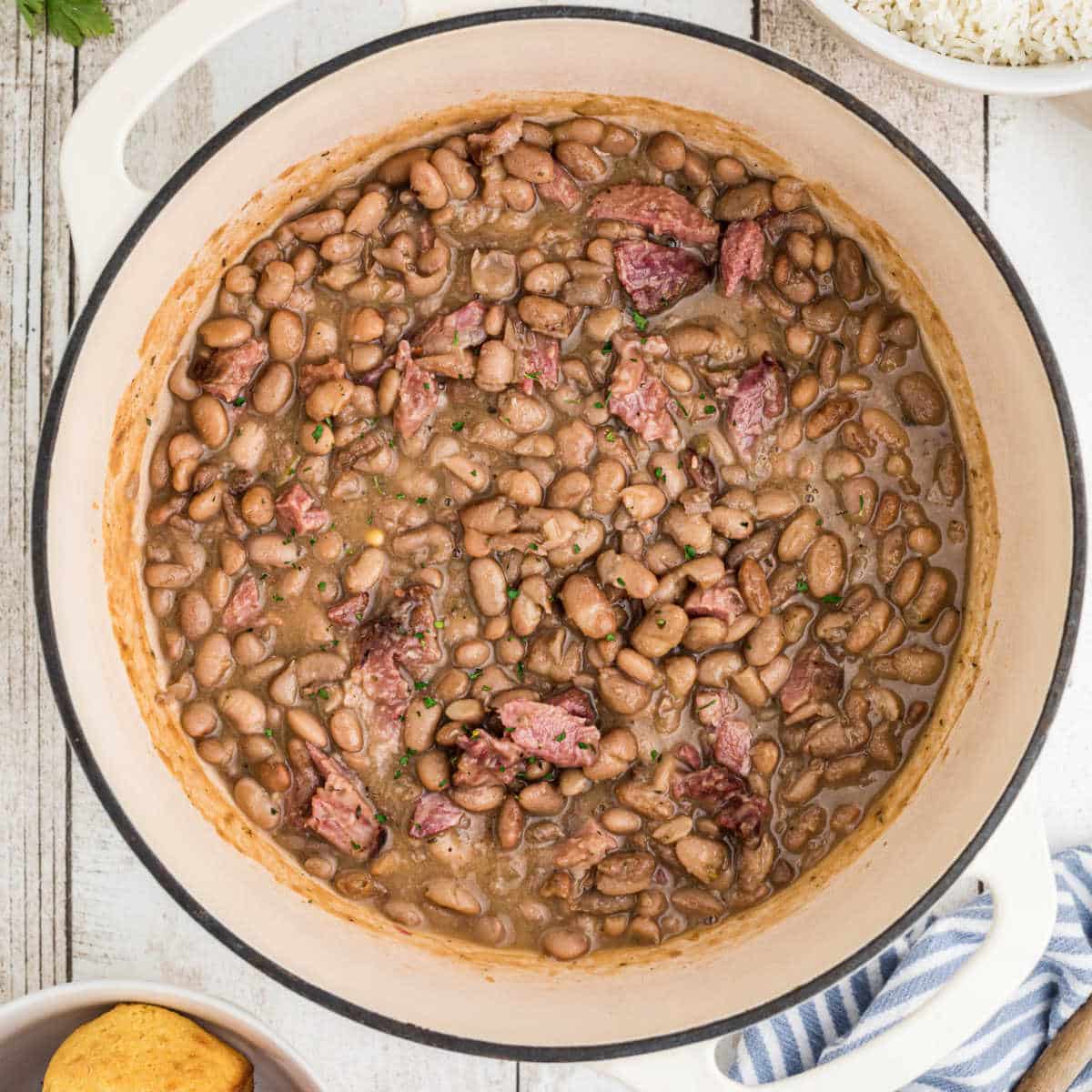 Overhead shot of a pot of pinto beans, cropped square.