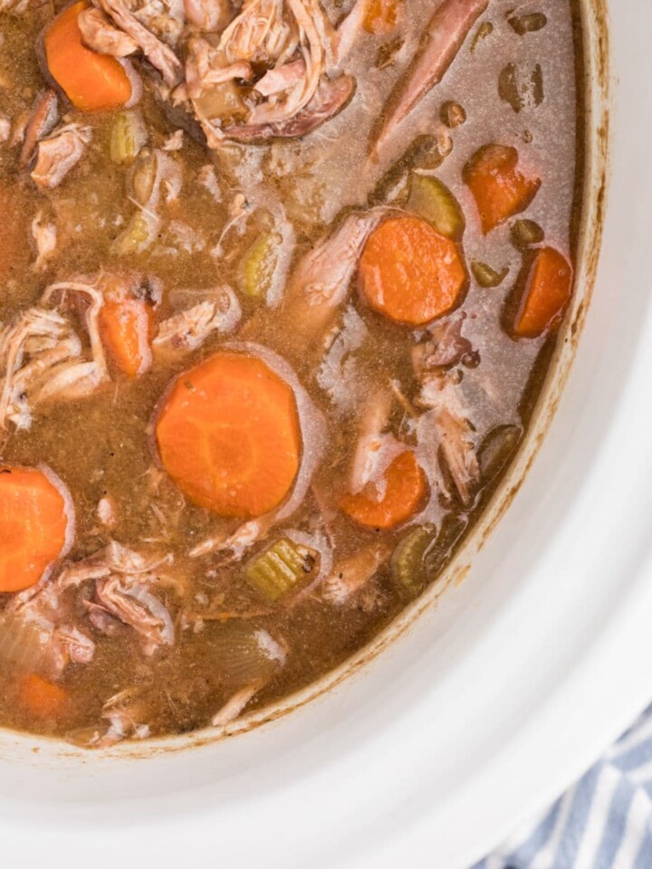 Overhead close up view of a slow cooker rabbit stew.