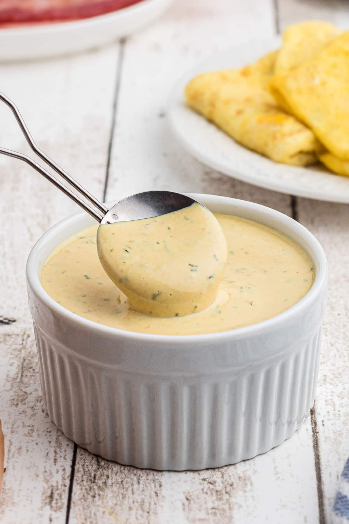 Close up shot of a bowl of mcdonald's breakfast sauce with spoon.