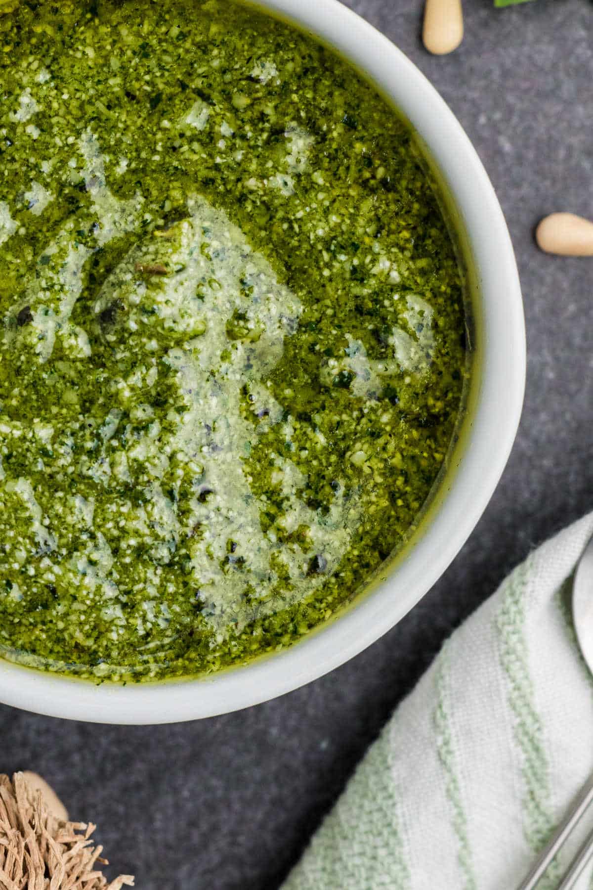 Overhead close up shot of a bowl of pesto dressing.