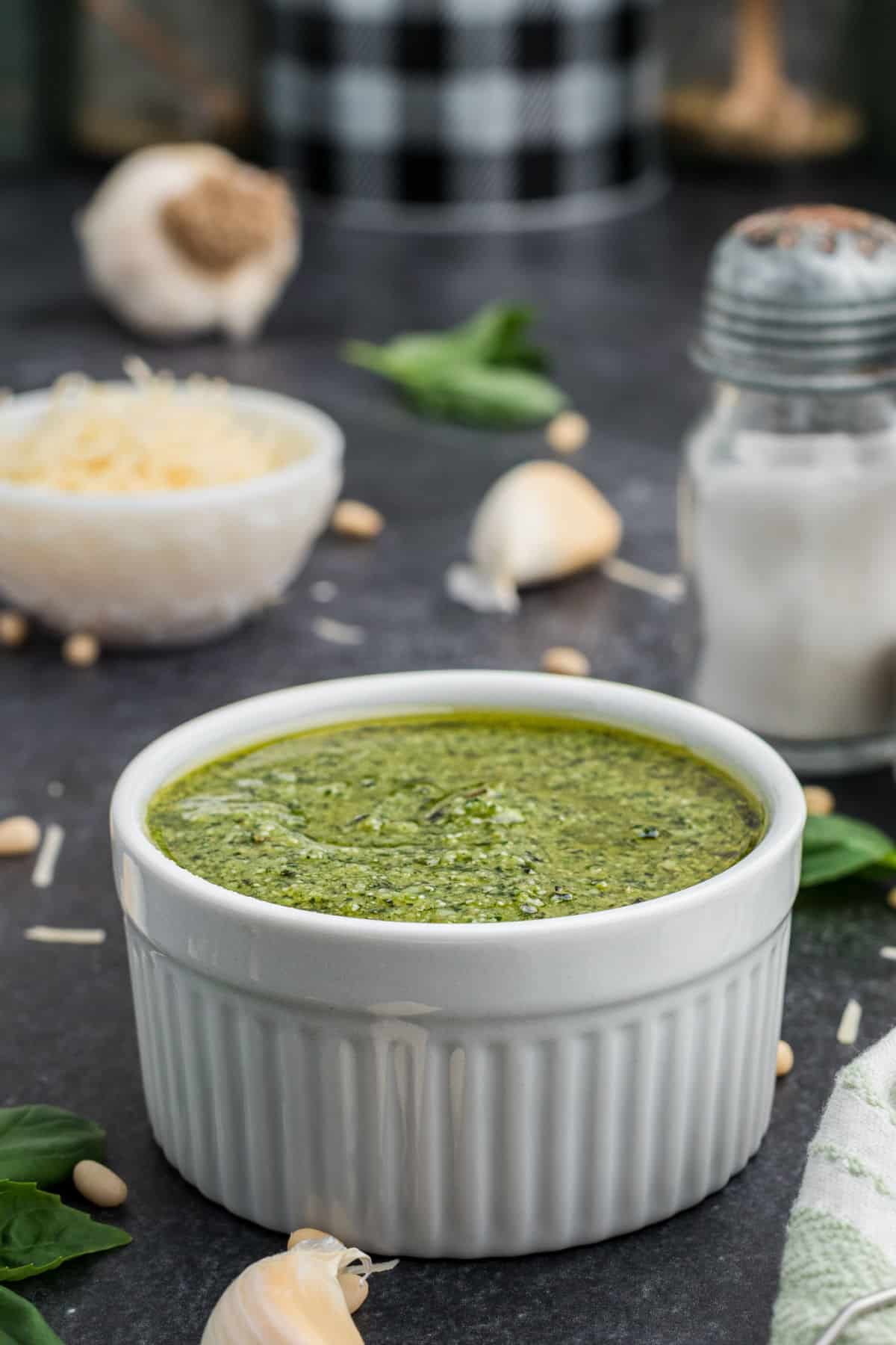 Side shot of a bowl of pesto dressing.