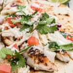 Close up of redfish tacos with text overlay for pinterest.