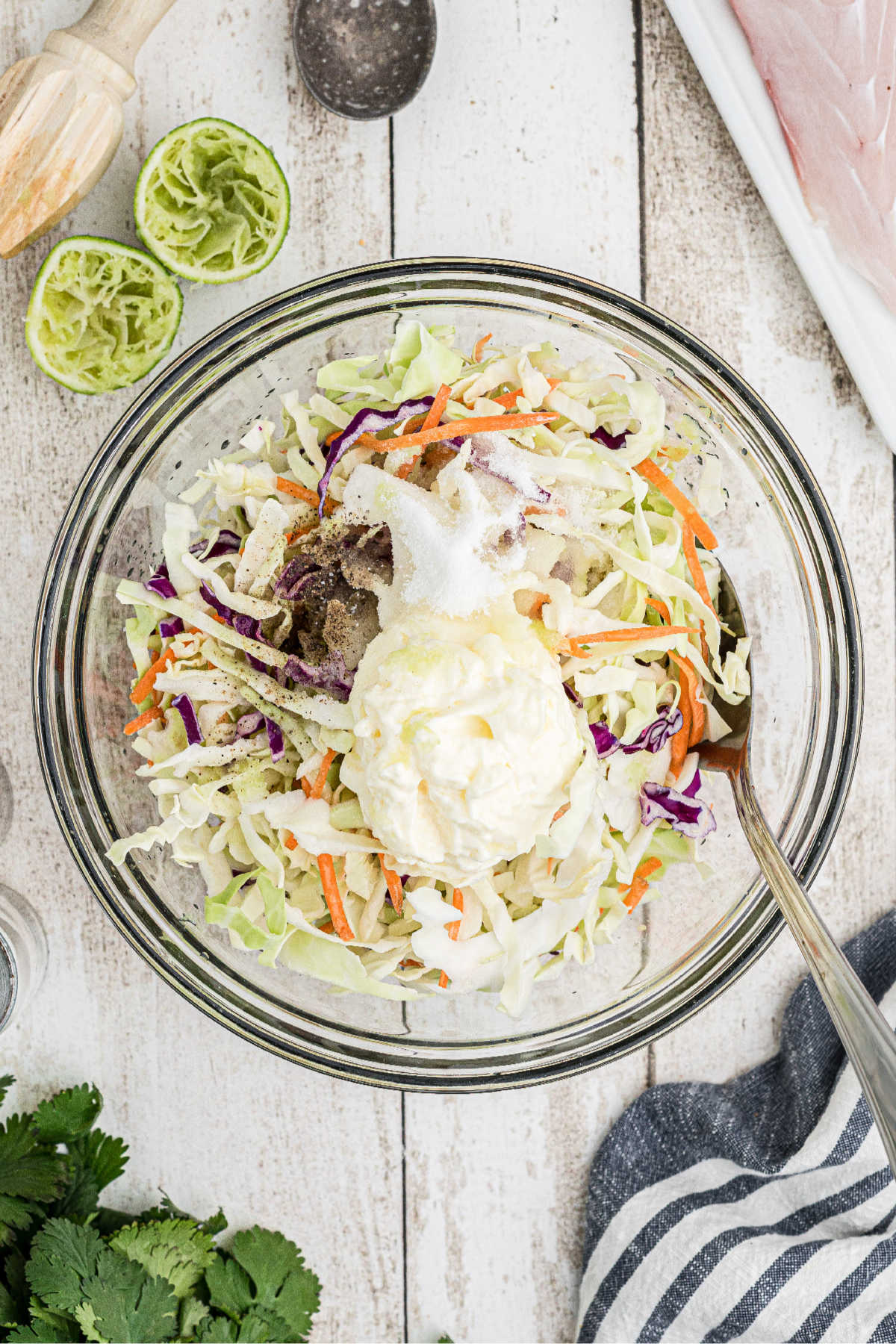 A bowl full of coleslaw ingredients, ready to be mixed.