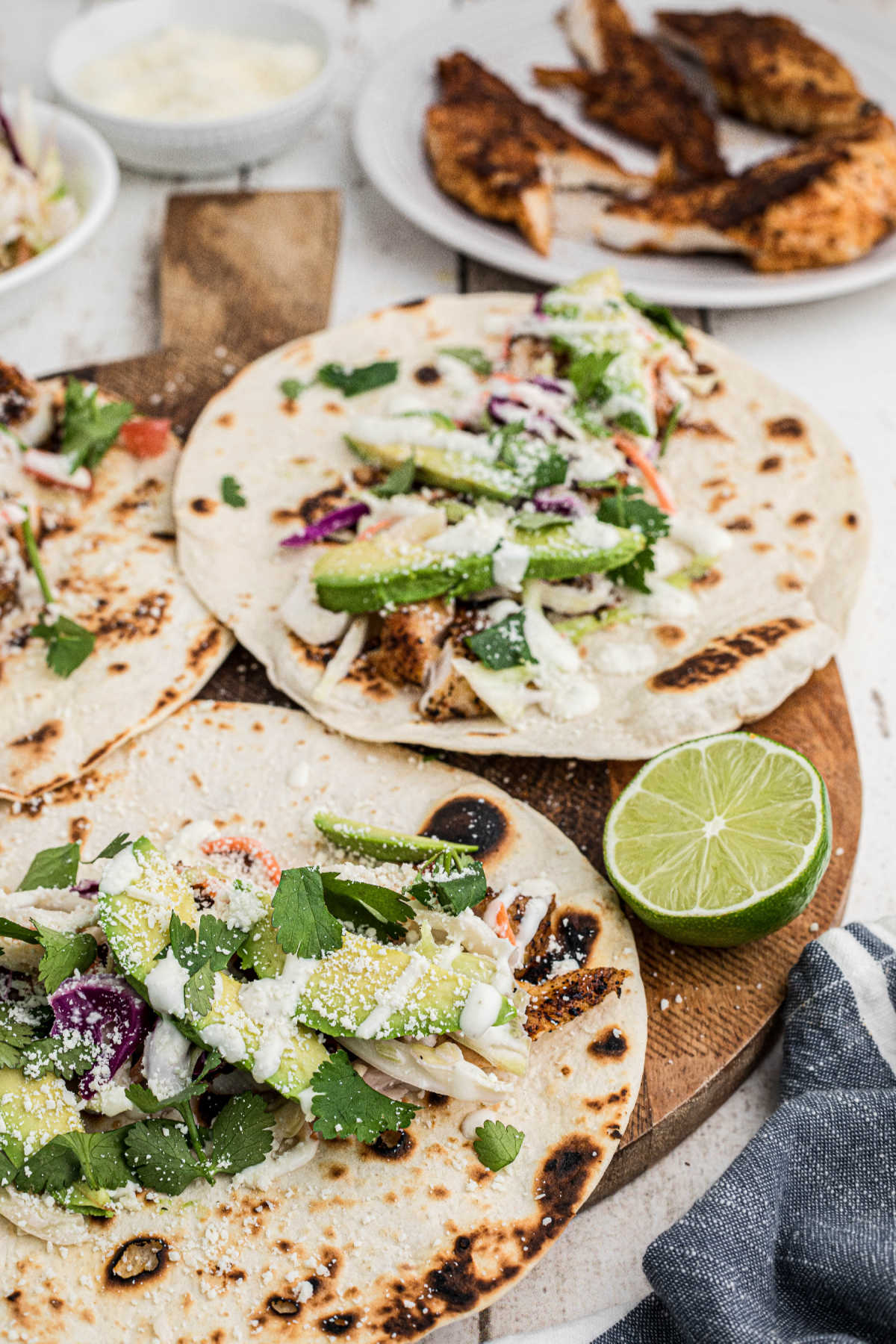 A board full of fish tacos being assembled.
