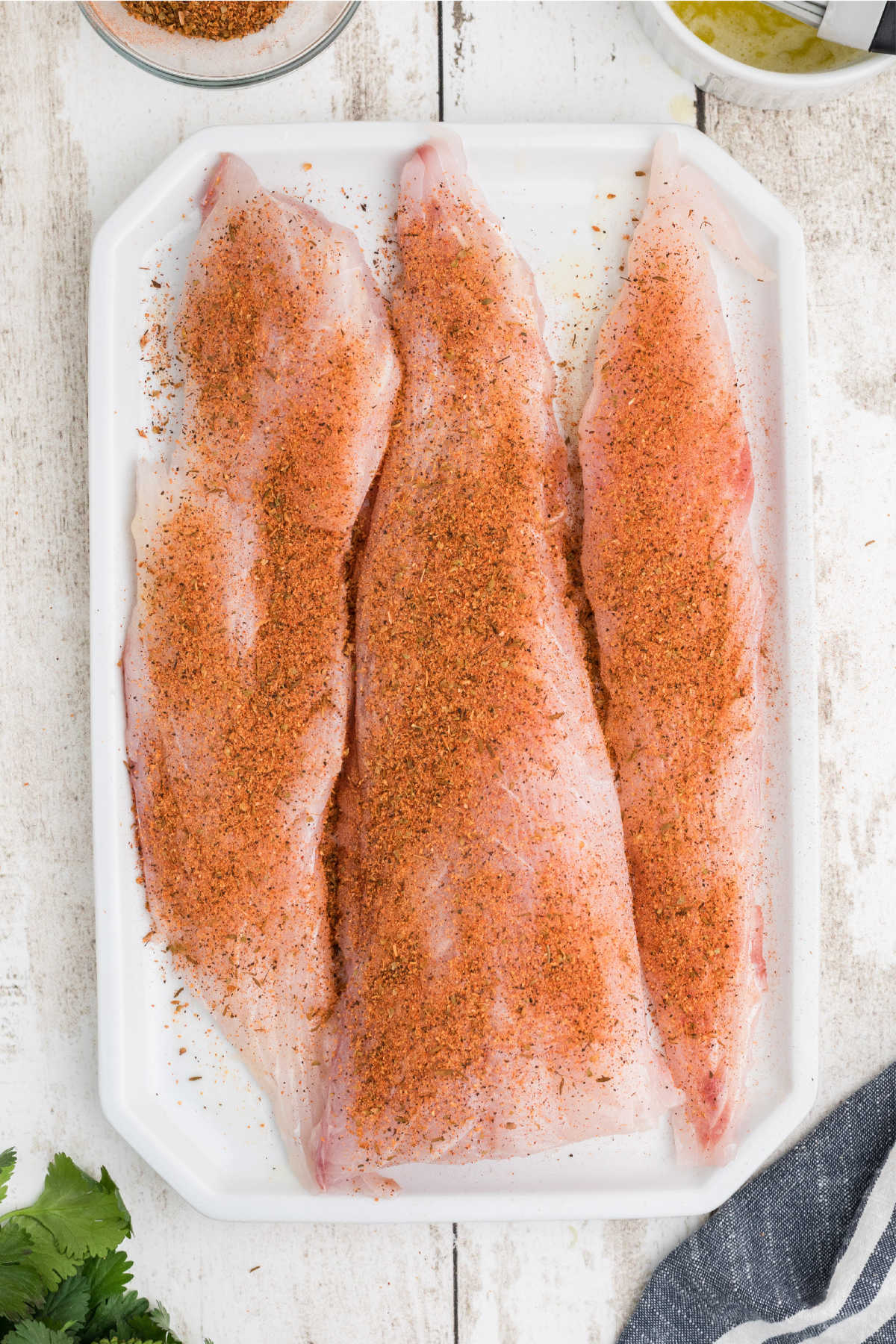 Redfish fillets seasoned liberally.