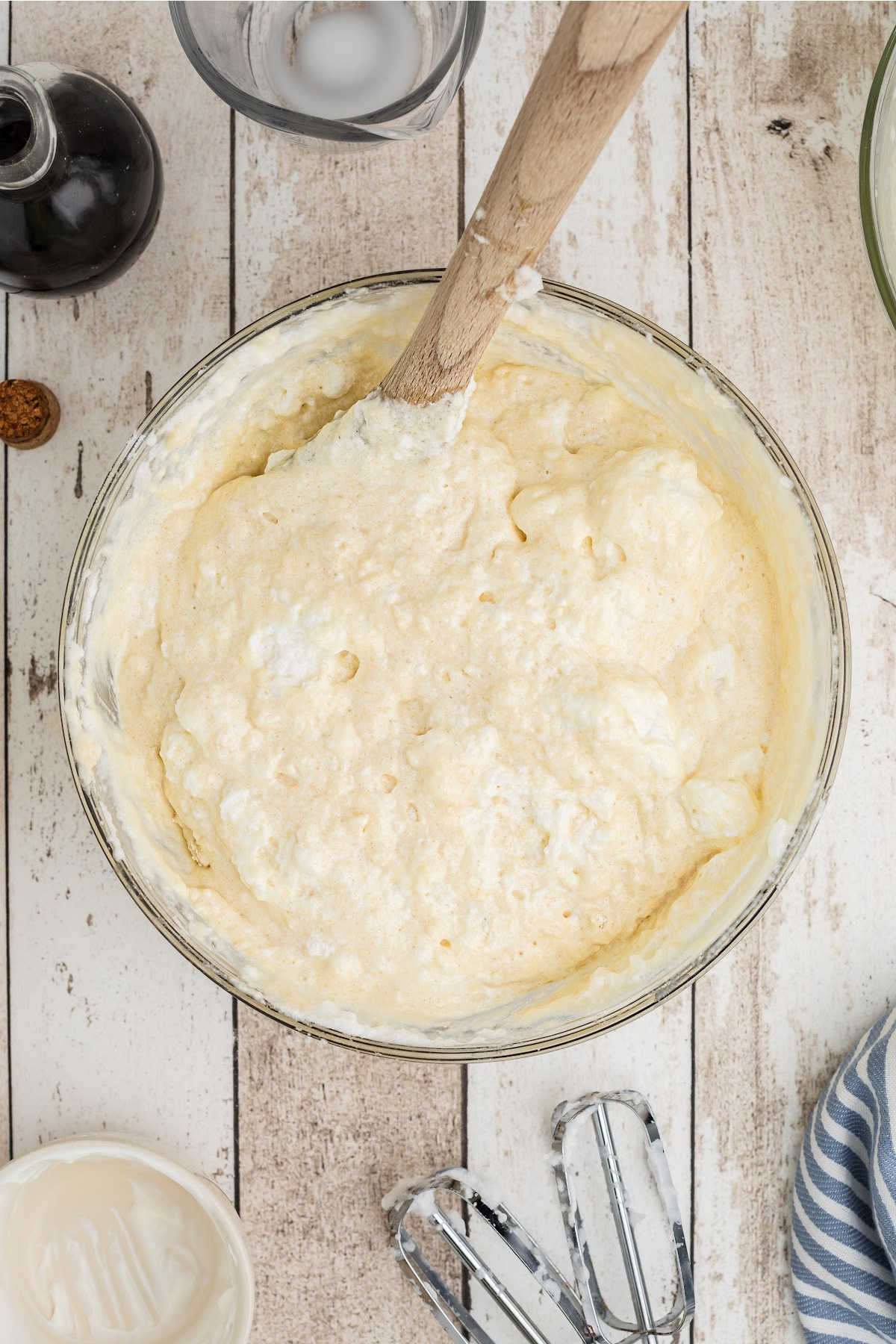 Fluffy egg whites being folded into a batter.