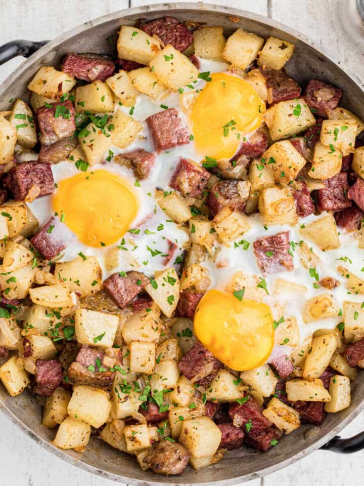 Overhead and cropped square, a skillet with a traditional Irish corned beef hash recipe.