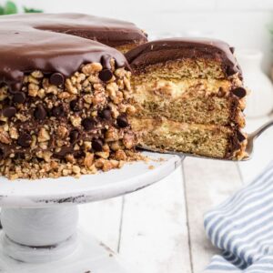 A piece of cake being removed from a banana dream cake.