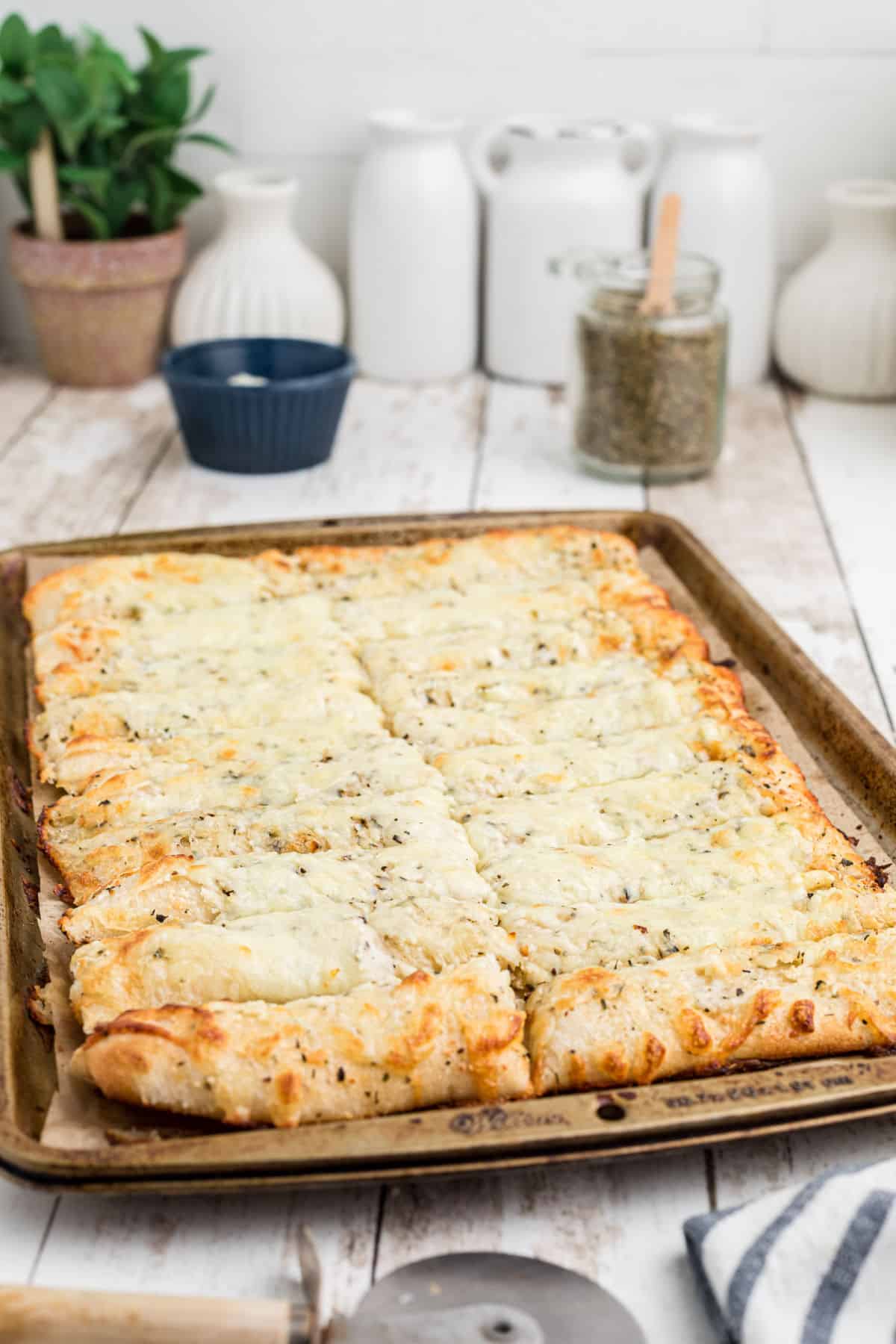Side view of a tray full of Italian Cheese Bread.