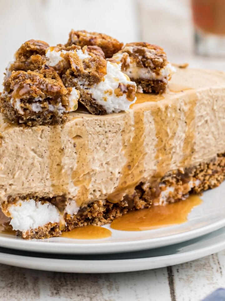 A slice of oatmeal creme pie cheesecake with caramel sauce drizzled on top.