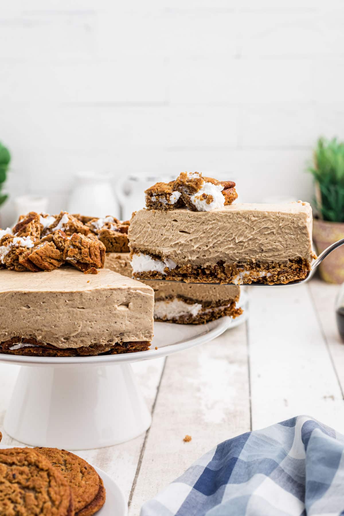 A slice of oatmeal creme pie cheesecake being lifted out of the whole thing.