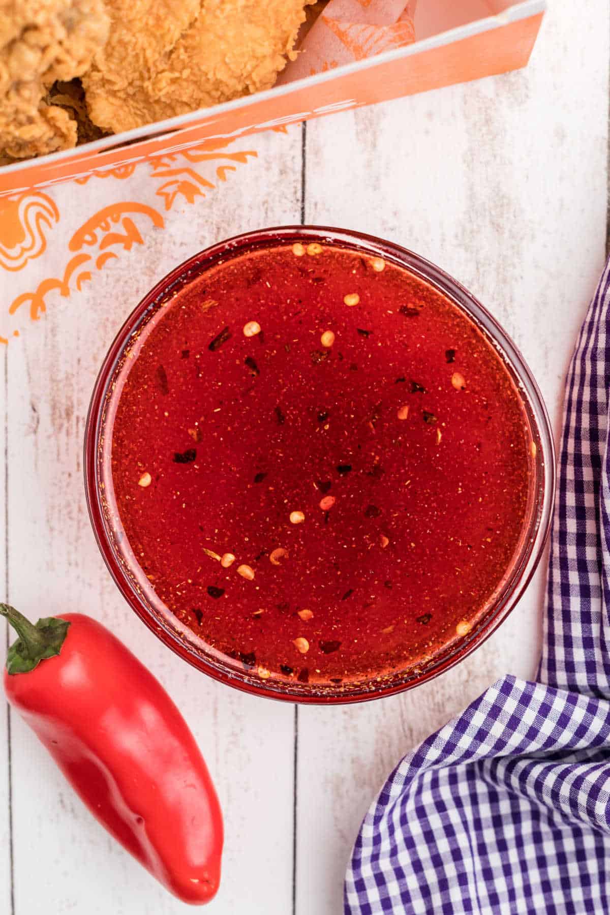 Overhead shot of a bowl of popeyes sweet heat sauce recipe.