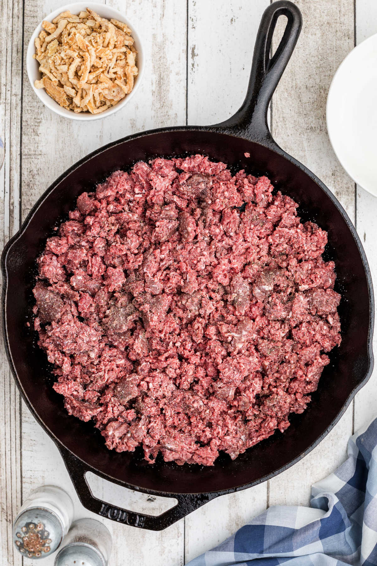 Overhead image of a cast iron skillet with ground beef.