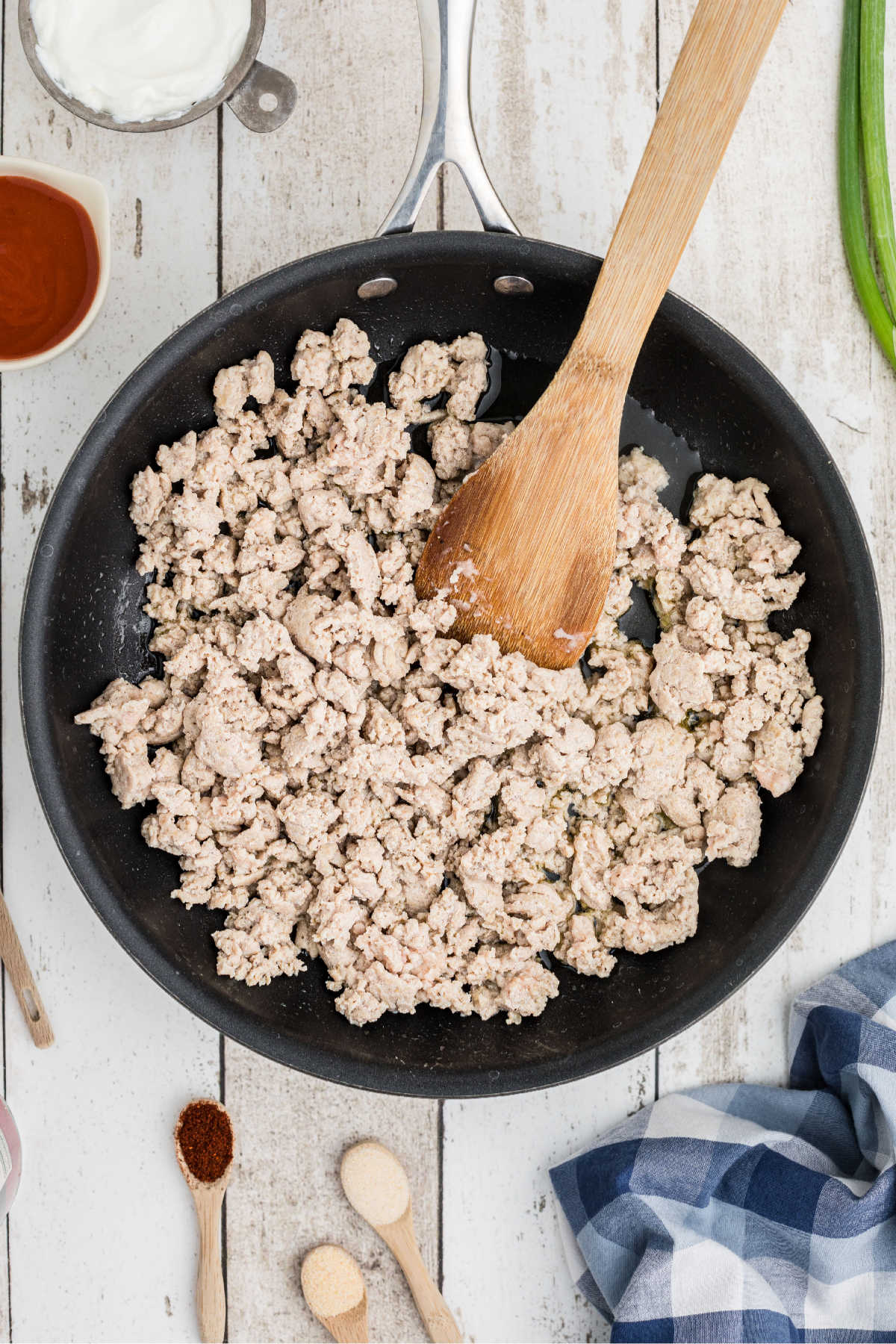 A skillet with ground chicken being browned.