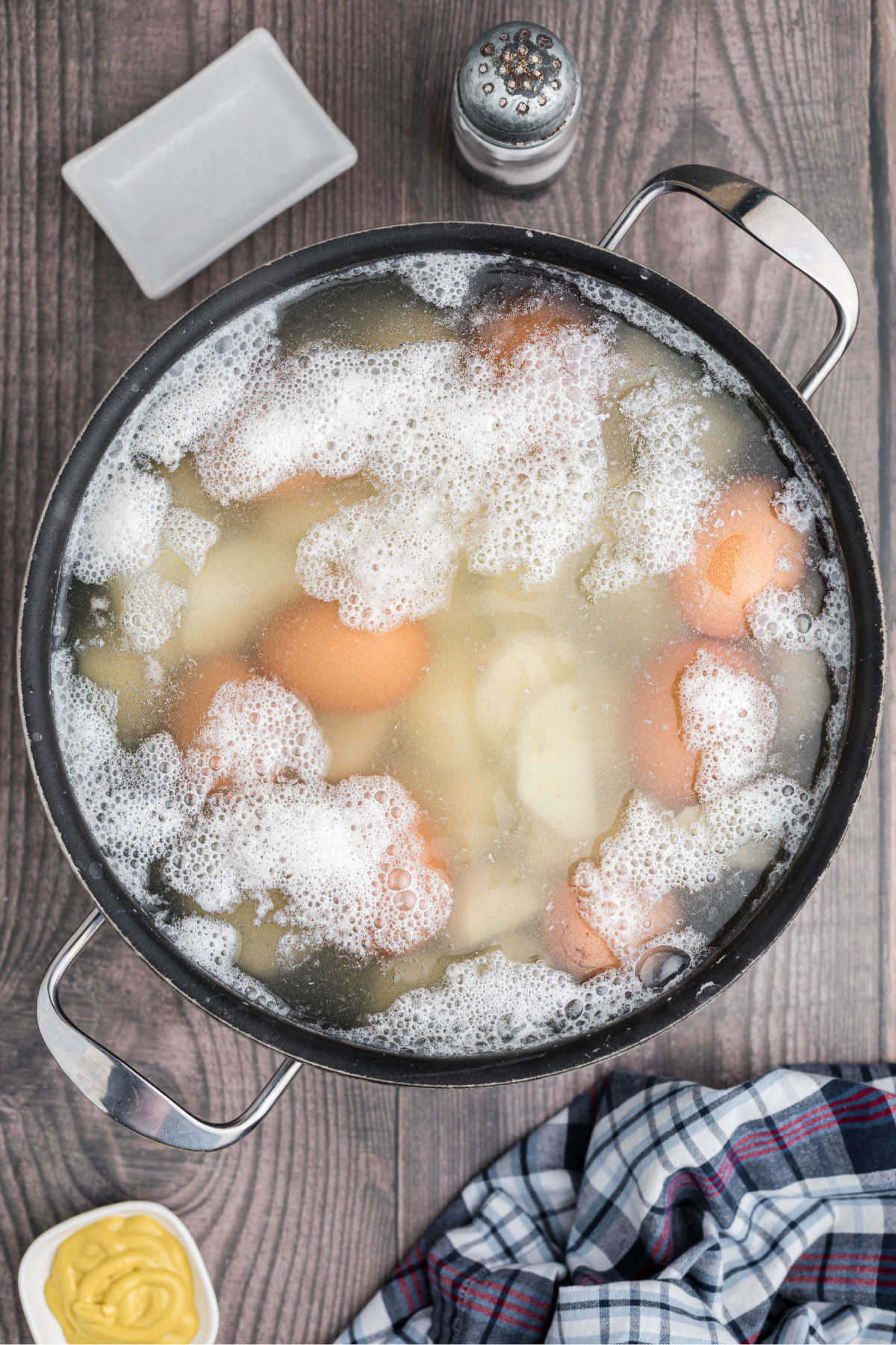 Eggs added to boiling potatoes, to cook too.