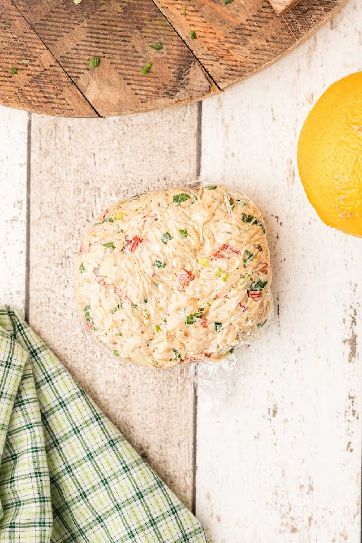 Crab meat mixture formed into patties and wrapped in plastic wrap.