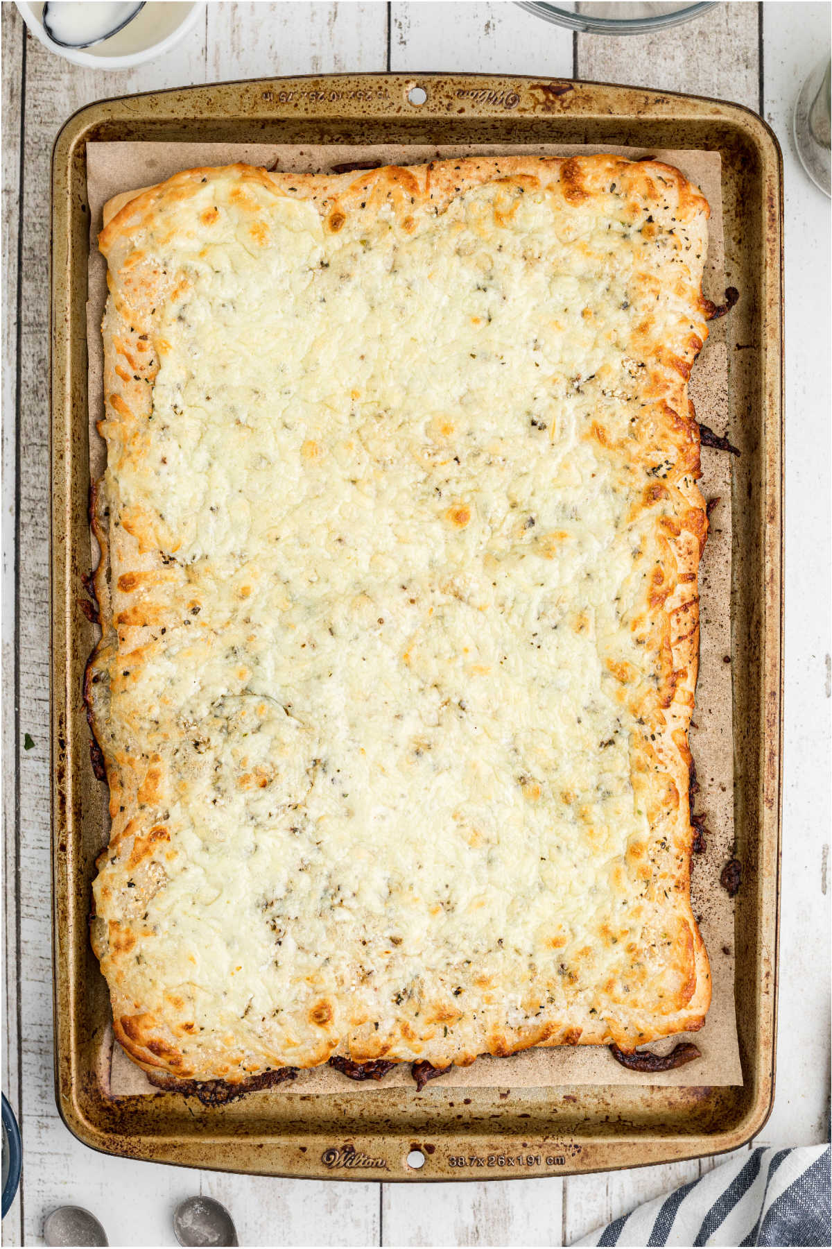 A baked pizza crust that looks nice and cheesy.