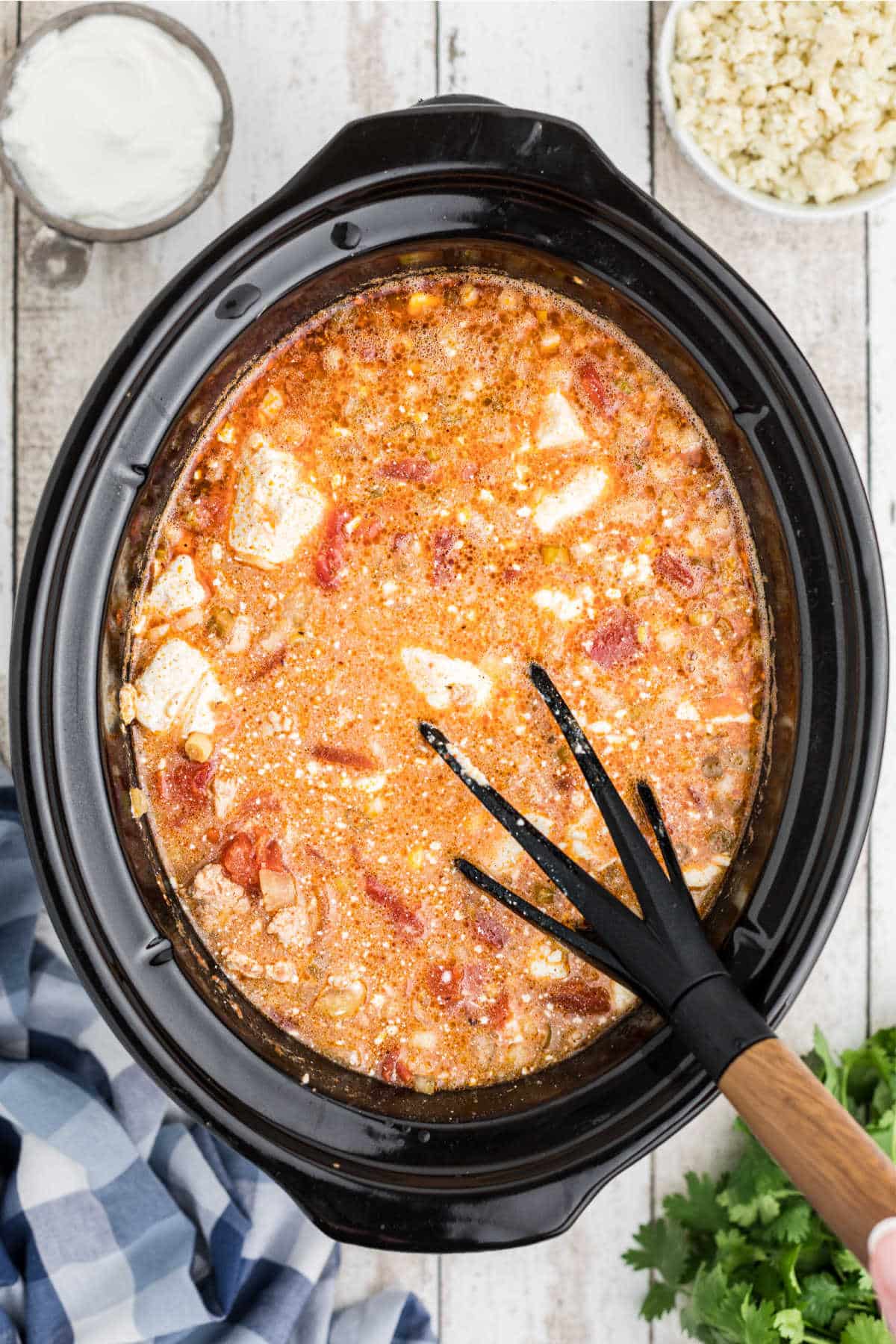 Cream cheese added to a slow cooker buffalo chicken chili recipe.