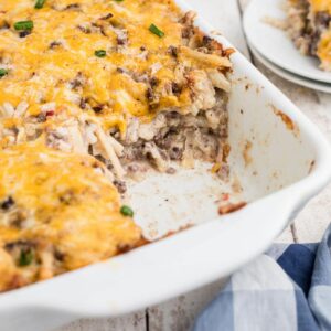 Side shot of a hamburger hashbrown casserole, cropped square.