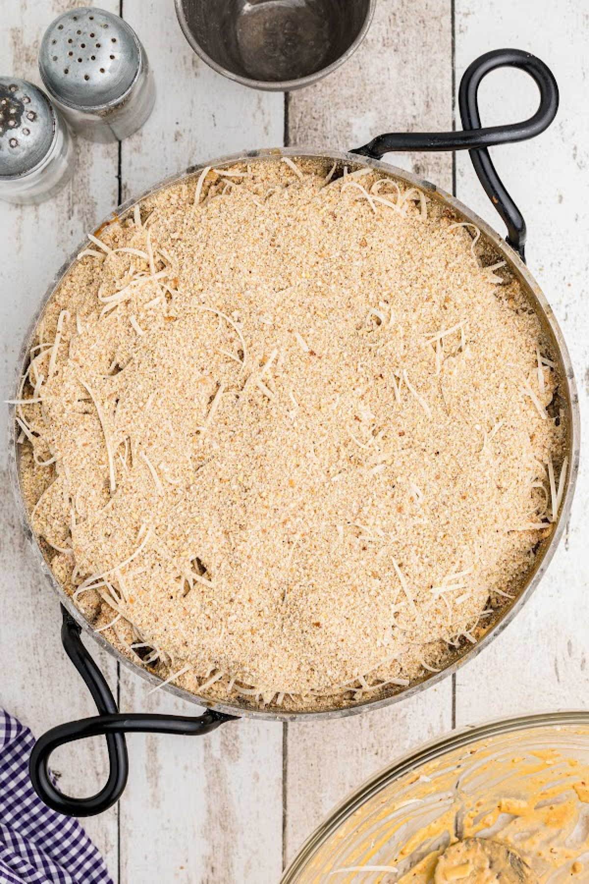 Breadcrumbs on top of a crawfish dip in a skillet.
