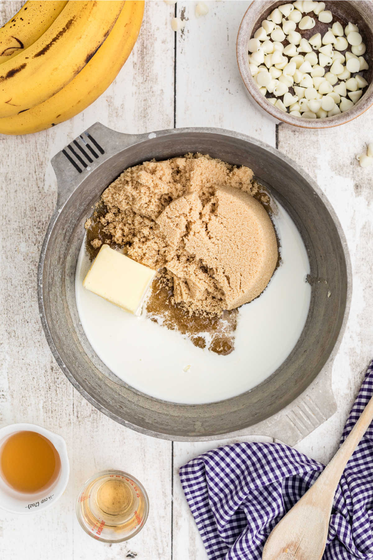 A small pot with sugar, milk and butter about to be cooked.